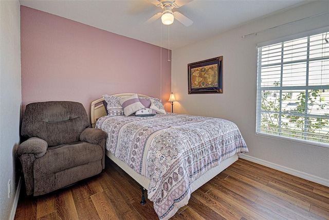 bedroom with ceiling fan and dark hardwood / wood-style floors