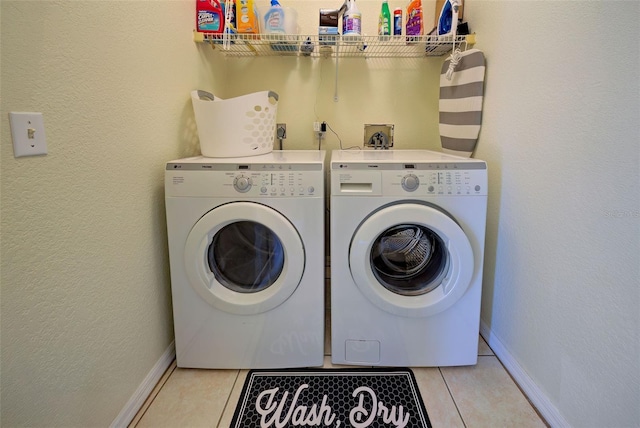 laundry room featuring independent washer and dryer and light tile patterned floors