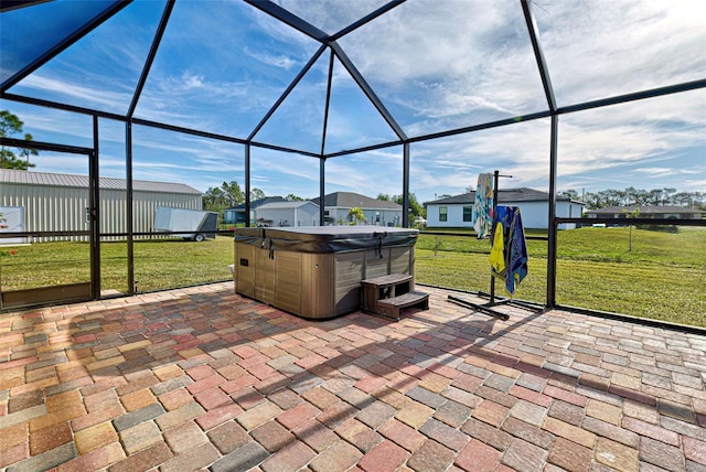 view of patio featuring a lanai and a hot tub