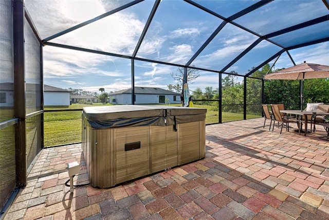 view of patio / terrace featuring a hot tub and a lanai