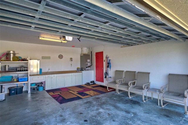 garage with stainless steel refrigerator, a garage door opener, and heating unit