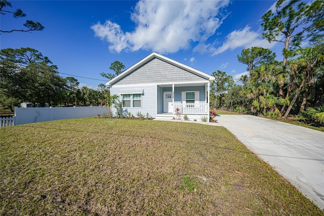 view of front of home featuring a front yard and a porch