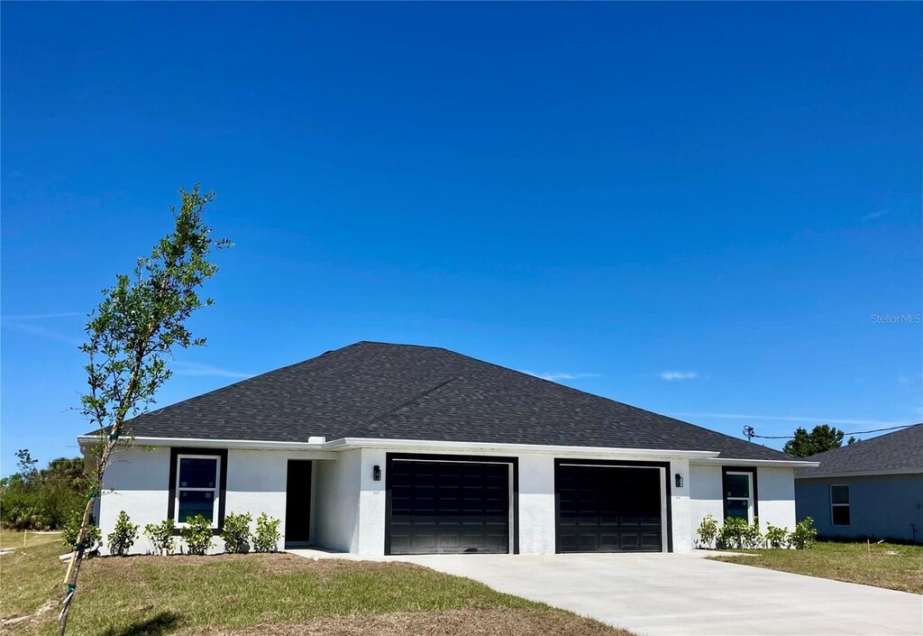 12046 Tetzel Ave, Port Charlotte, FL 33981 - ranch-style house featuring a front lawn, stucco siding, a garage, and concrete driveway