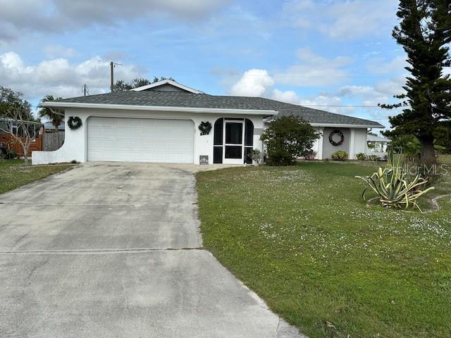 single story home featuring a front lawn and a garage