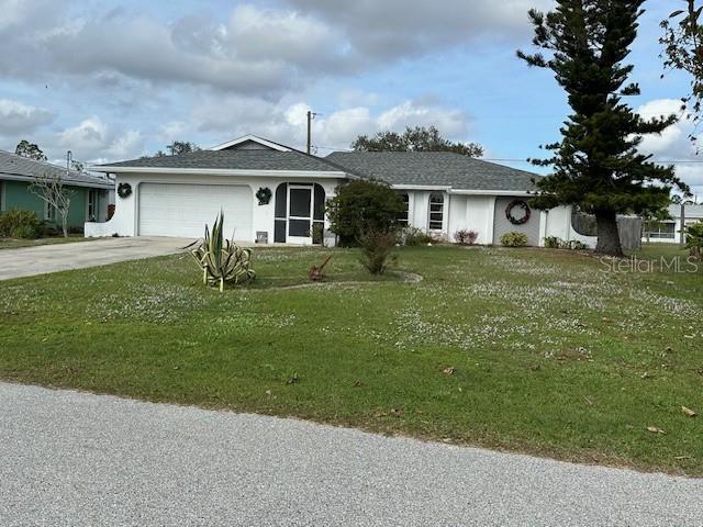 single story home with a front yard and a garage