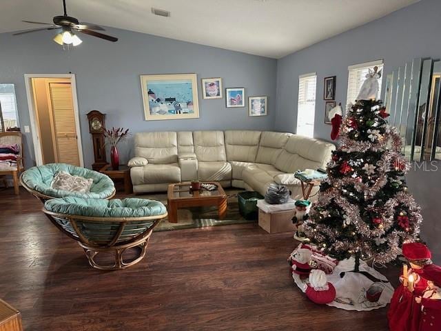 living room with ceiling fan, dark hardwood / wood-style flooring, and vaulted ceiling