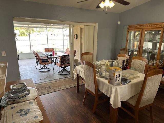 dining area featuring ceiling fan and dark wood-type flooring