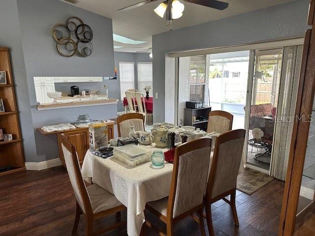 dining space featuring ceiling fan and dark hardwood / wood-style flooring