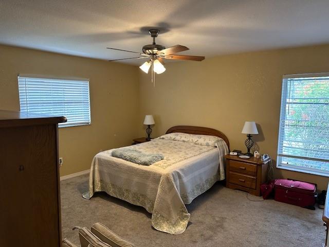 carpeted bedroom featuring ceiling fan