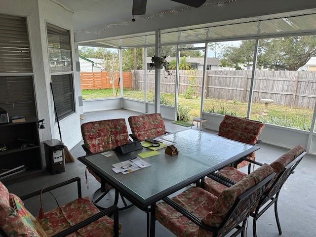 sunroom / solarium featuring ceiling fan