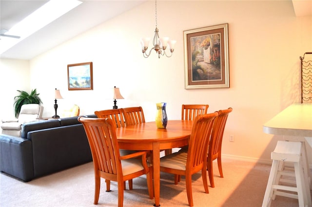 dining room featuring light carpet, ceiling fan with notable chandelier, and lofted ceiling