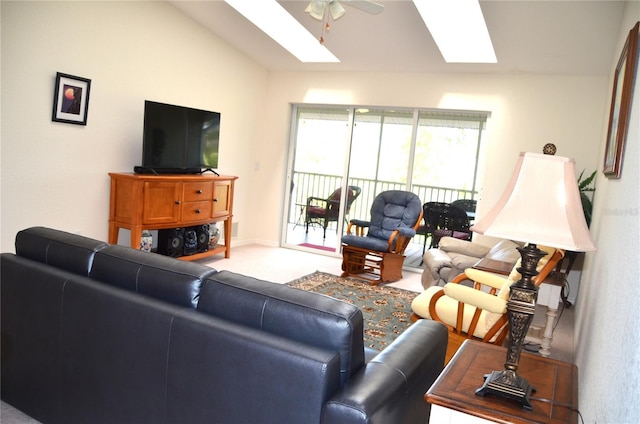 living room with ceiling fan and lofted ceiling with skylight