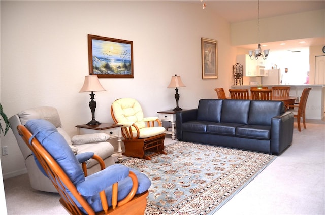 carpeted living room with an inviting chandelier