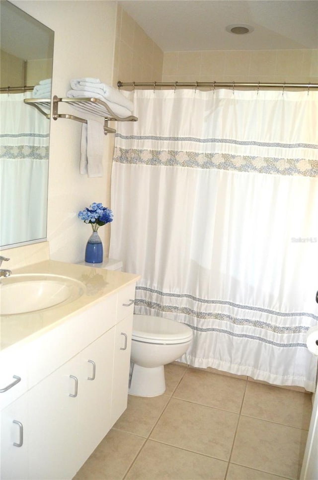 bathroom with tile patterned flooring, vanity, and toilet