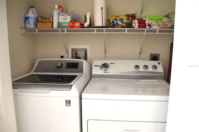 clothes washing area featuring independent washer and dryer