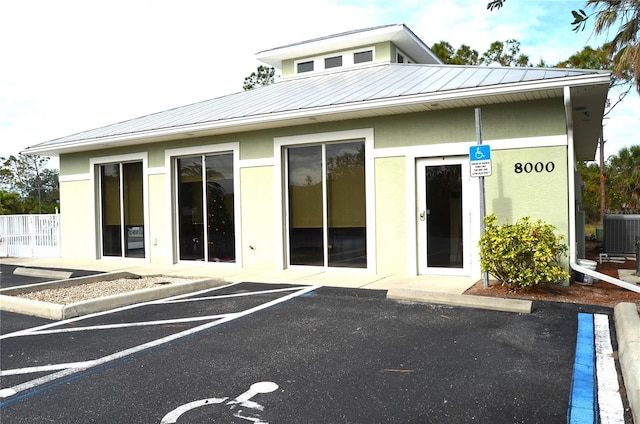 rear view of property with central AC