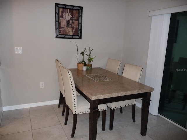 dining space featuring tile patterned flooring