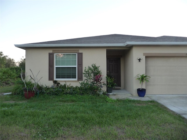 ranch-style house featuring a front lawn and a garage