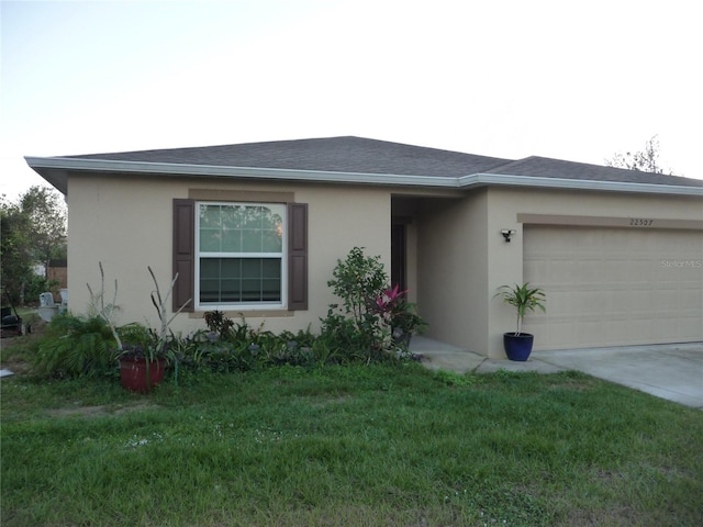 ranch-style home with a front lawn and a garage