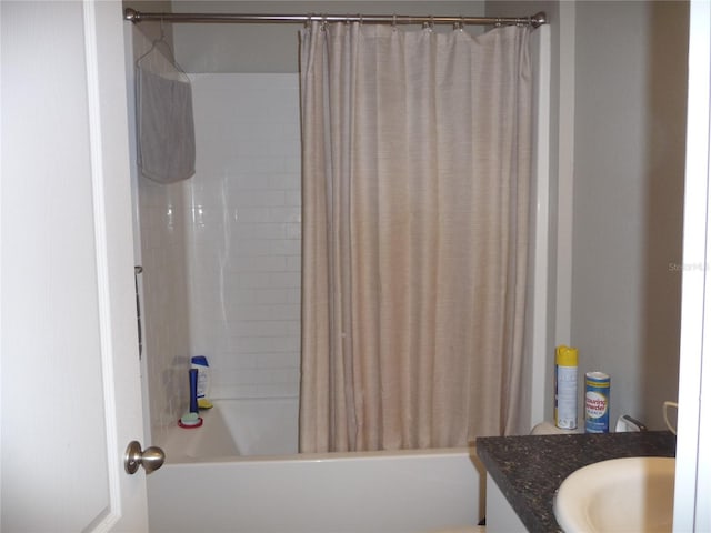 bathroom featuring vanity and shower / bathtub combination with curtain