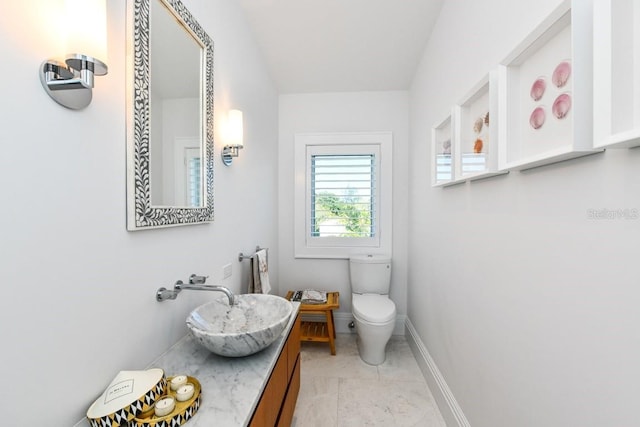 bathroom featuring toilet and vanity