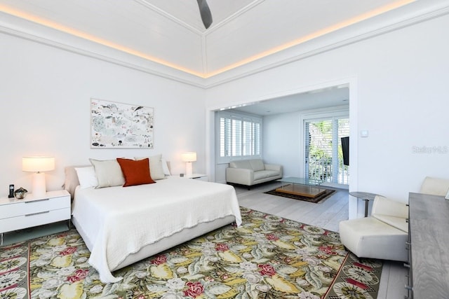 bedroom with ceiling fan, wood-type flooring, and ornamental molding