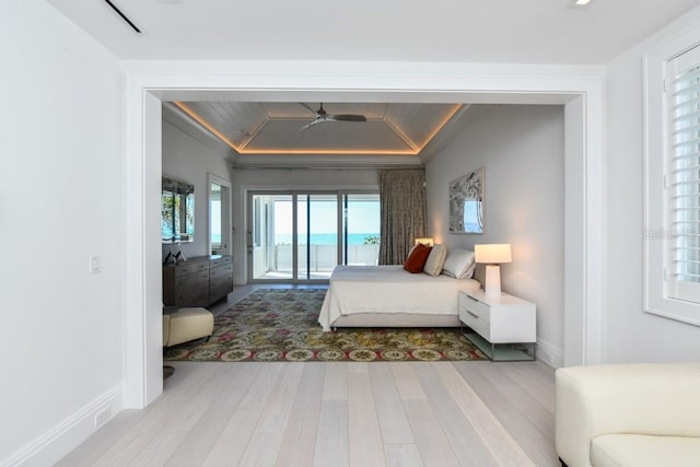 bedroom with access to exterior, ornamental molding, and light hardwood / wood-style flooring