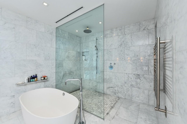 bathroom featuring tile walls and shower with separate bathtub