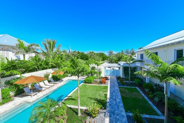 view of pool with a lawn and a patio