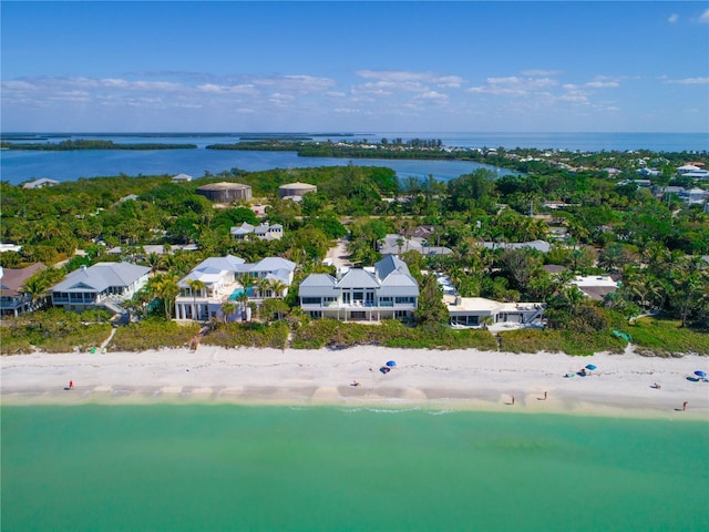 birds eye view of property featuring a water view and a view of the beach