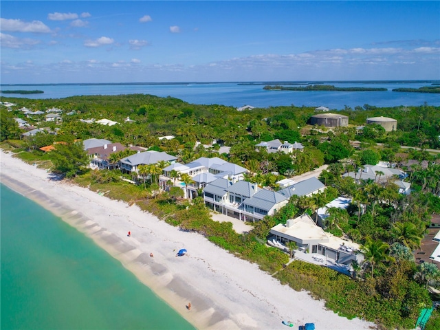 birds eye view of property with a water view and a view of the beach