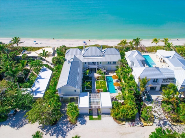 bird's eye view with a water view and a beach view