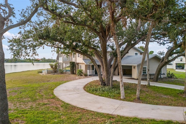 view of front of home featuring a water view and a front lawn