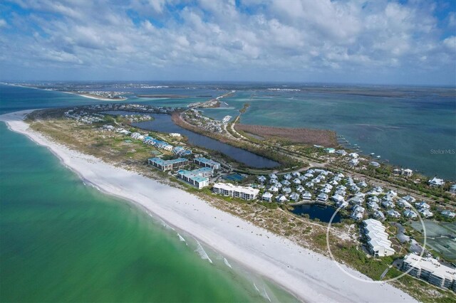 bird's eye view with a water view and a beach view