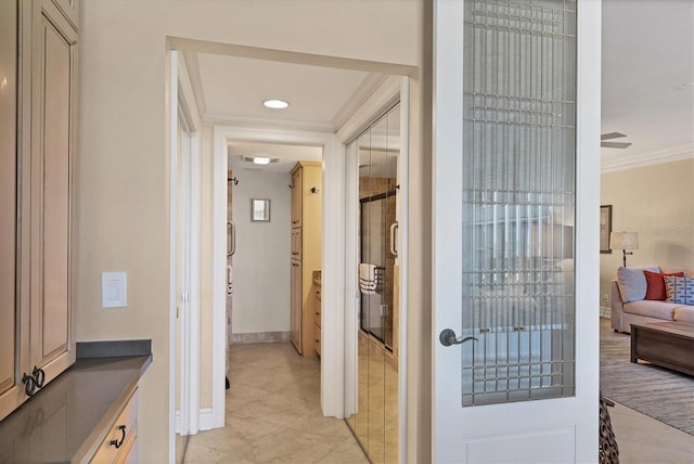 entryway with light tile patterned floors and ornamental molding