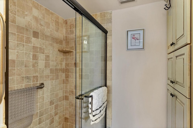 bathroom featuring a shower with door