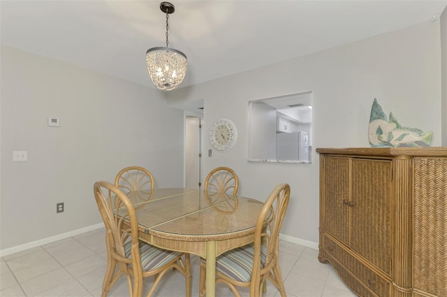 tiled dining space with a notable chandelier