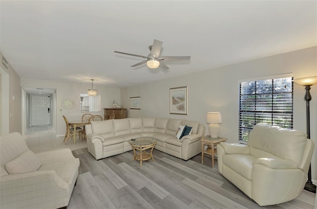 living room featuring light hardwood / wood-style floors and ceiling fan