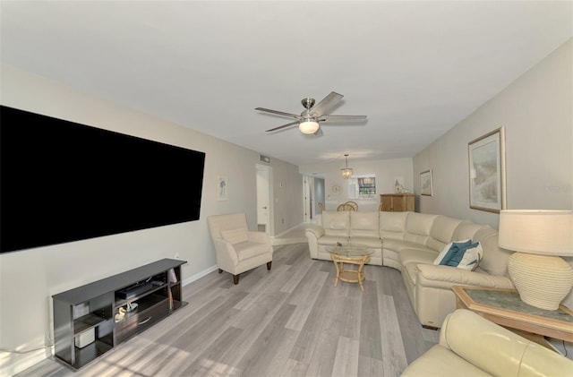 living room with light wood-type flooring and ceiling fan