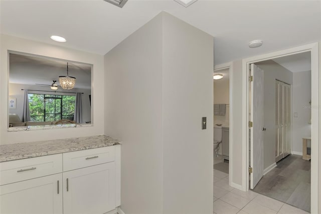 bathroom with tile patterned flooring, vanity, and ceiling fan