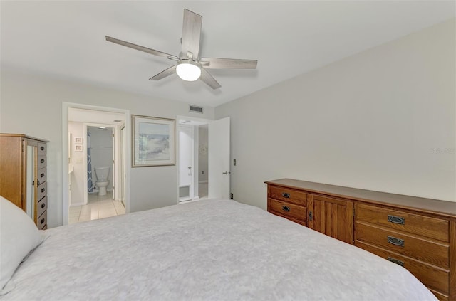 tiled bedroom with ceiling fan and ensuite bathroom