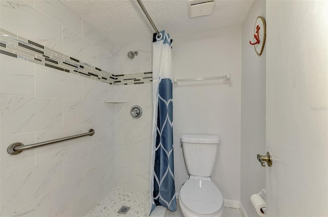 bathroom with toilet, a textured ceiling, and walk in shower