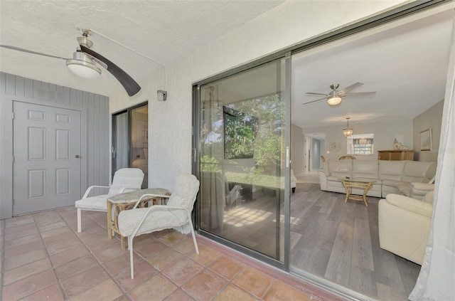 balcony with ceiling fan and a patio