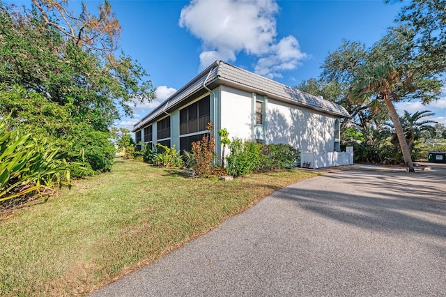 view of property exterior featuring a lawn