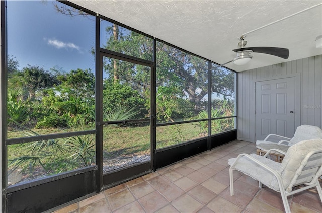 unfurnished sunroom with ceiling fan