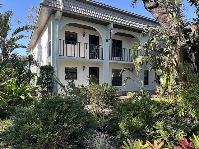 rear view of property featuring a balcony