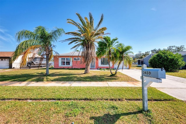 view of front of house with a front lawn and a garage