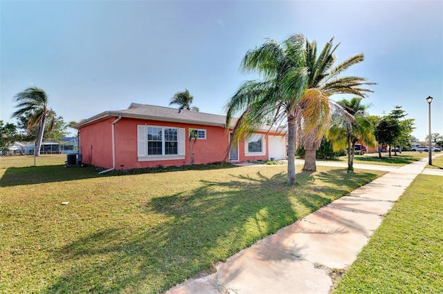 single story home featuring a front yard and central AC unit