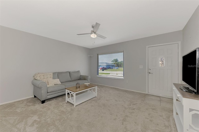 living room with ceiling fan and light colored carpet