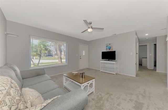 carpeted living room featuring ceiling fan